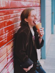 Photo of DJ with an ice cream cone. 