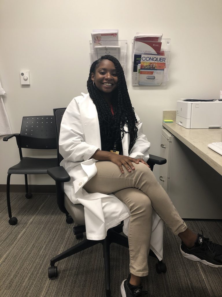 Andrea pictured in in a medical lab coat. 