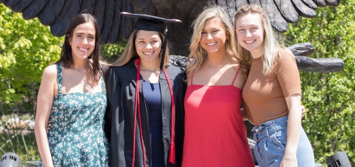 casey and three friends posing for a grad pic.