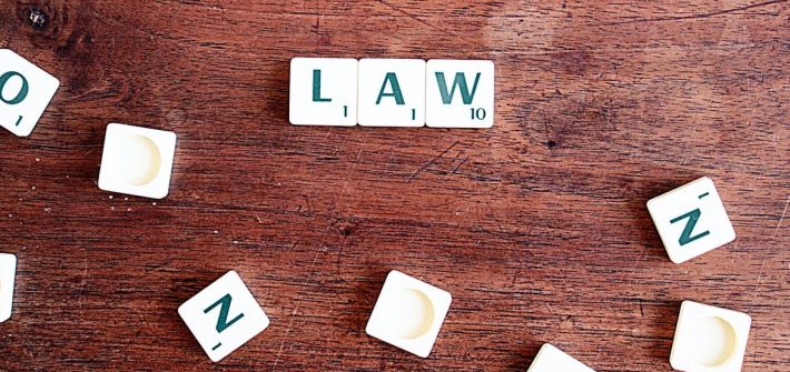 Stock image of Scrabble tiles spelling law.