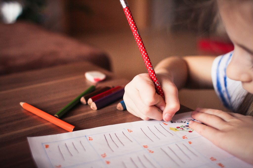 Stock image of a girl working on a school paper