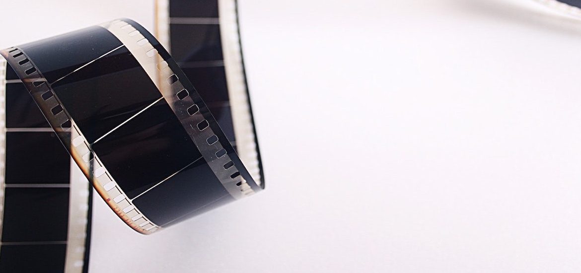 Stock photo of film unrolling against a white background.
