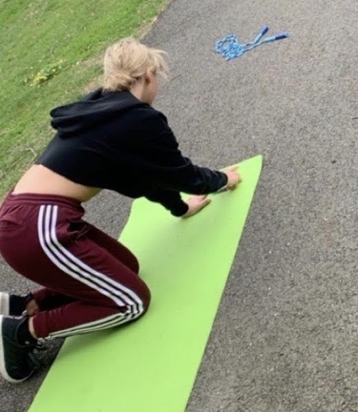 Lynzie doing a "HIIT" workout in her driveway. 
