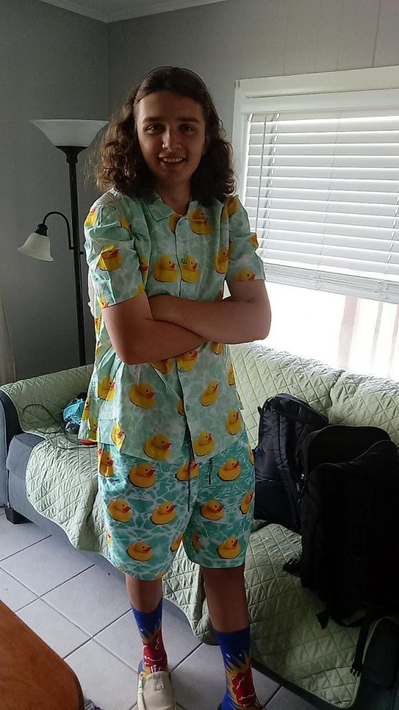 Portrait of Hunter in rubber duck patterned shirt and shorts at home