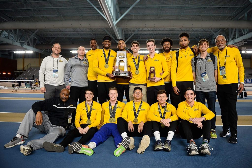 Francis poses with his team with their third place trophy.