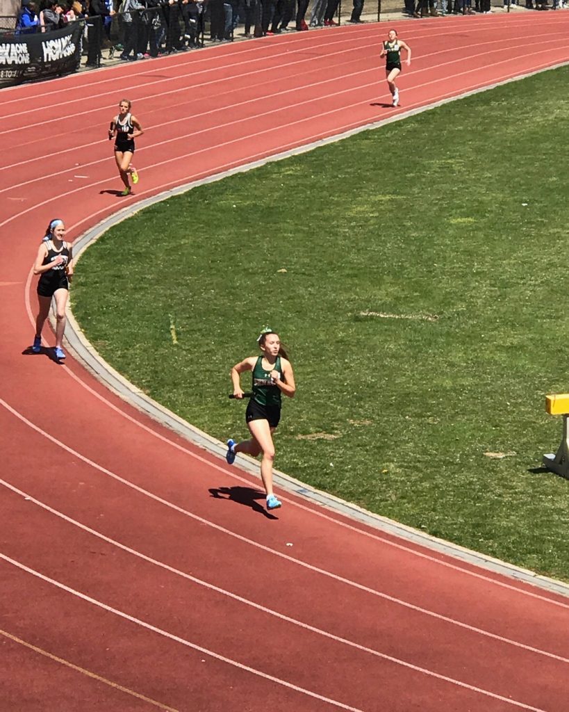 Photo of Amanda running track while in high school
