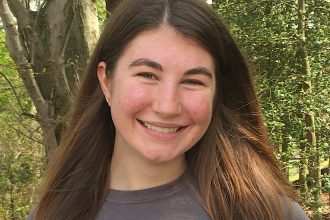 Photo of Megan outside in a wooded area
