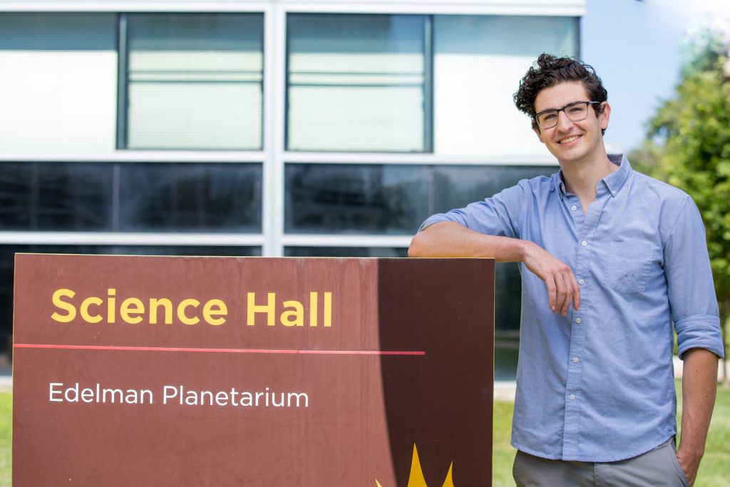 Aaron poses outside by Science Hall.