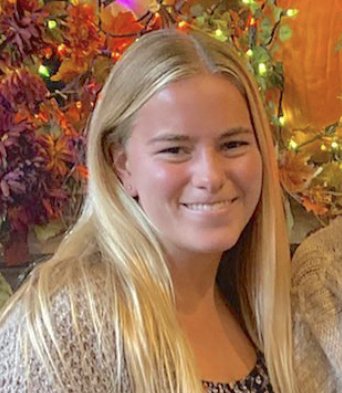 Headshot of Julia, who is smiling and has long blond hair.