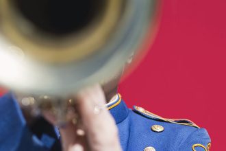 stock image of a trumpet player against a red background