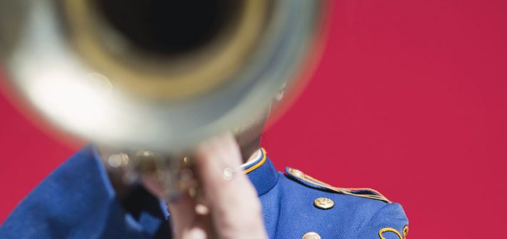 stock image of a trumpet player against a red background