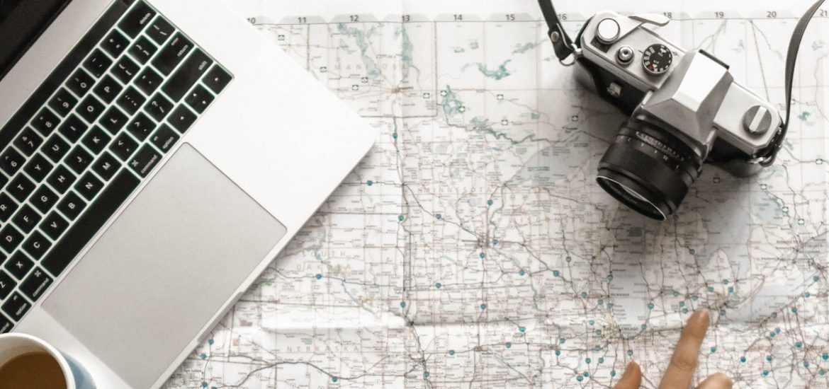 stock image of a laptop, map and a camera