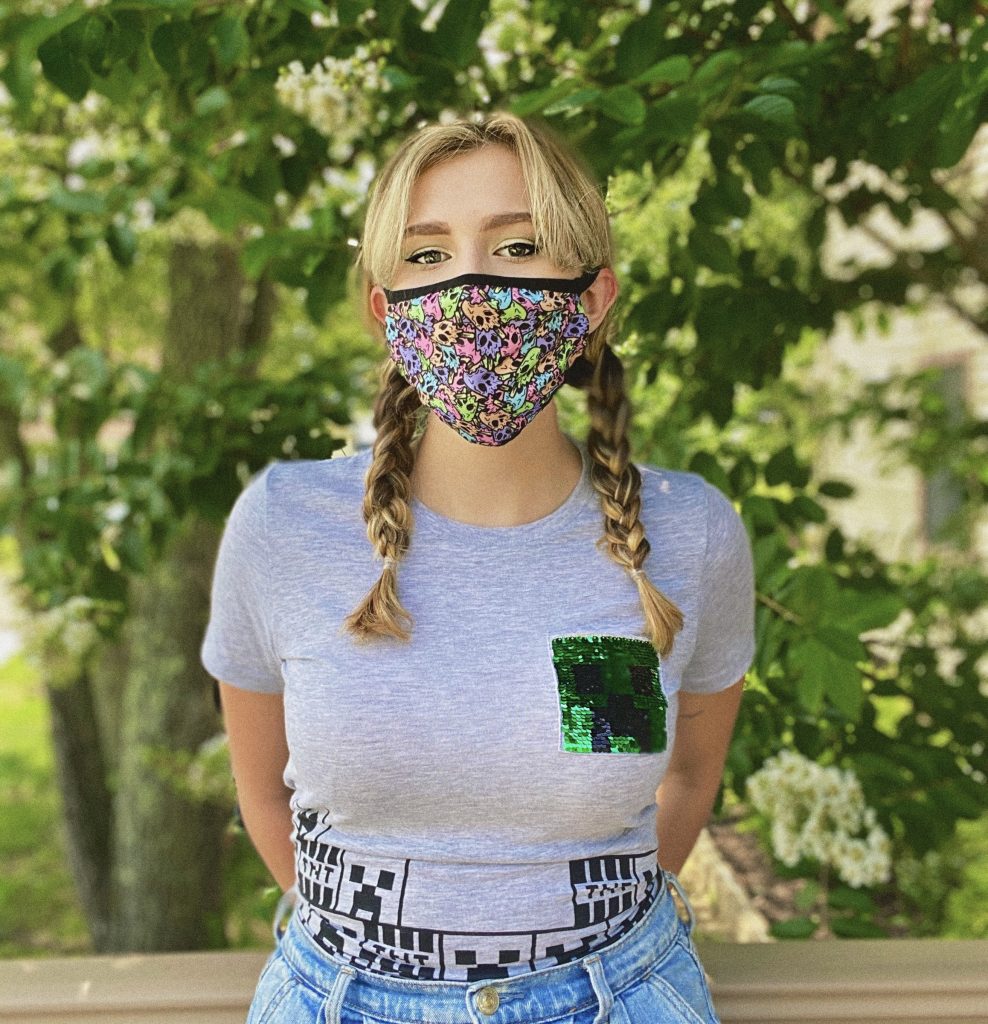 Biology major Jill Taylor wears her favorite web series mask and stands outside
