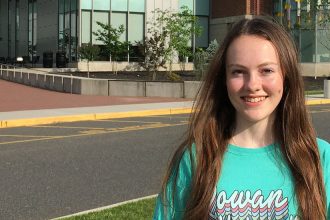 Lily stands in front of Business Hall.