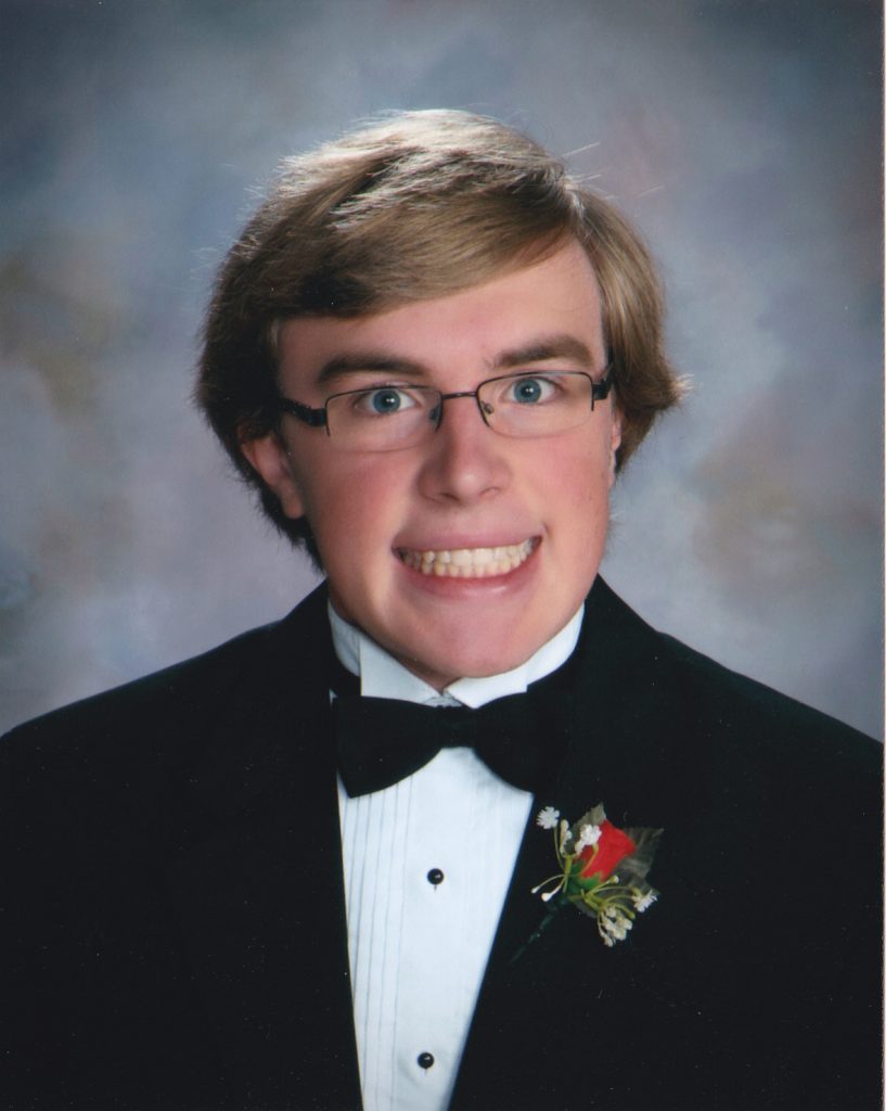 Larry smiling in his high school graduation photo.