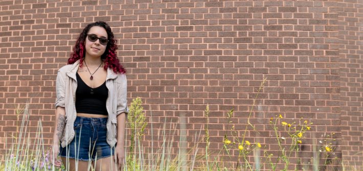 Stephanie at Wilson Hall with greenery and flowers