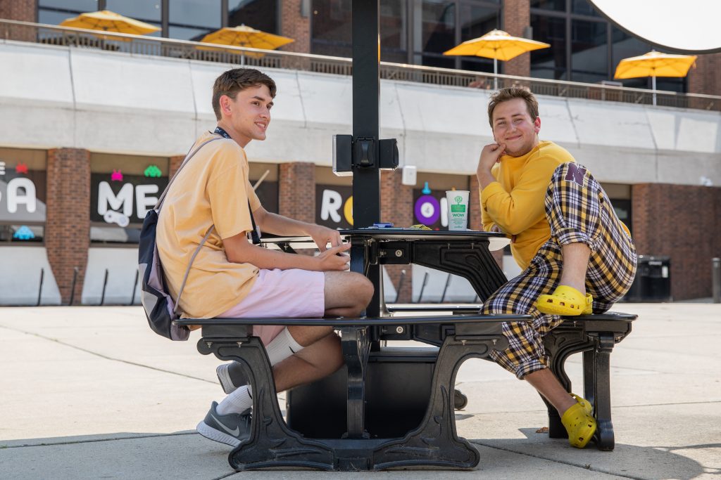 Connor and Ben sitting with each other outside the student center.