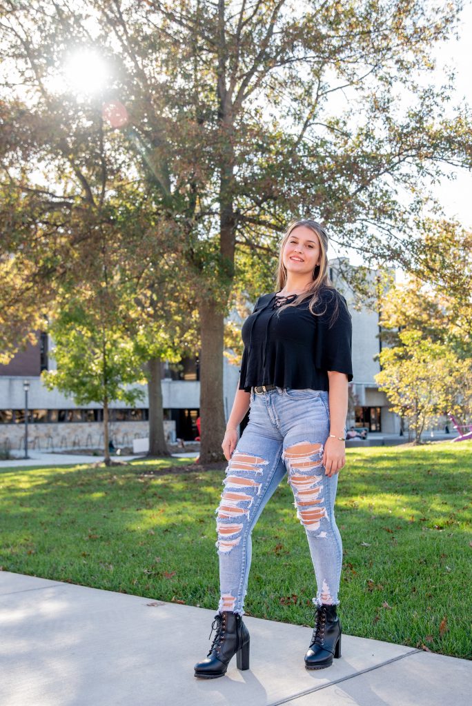 Daniella posing outside Robinson and Wilson Hall on campus.