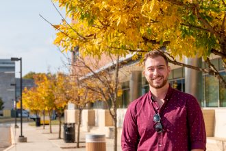Elementary education student poses outside on campus.