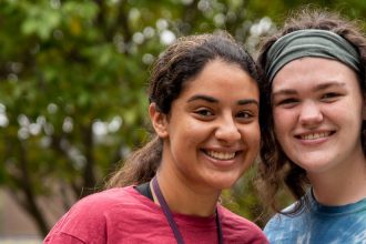 Roommates pose together outside on campus.
