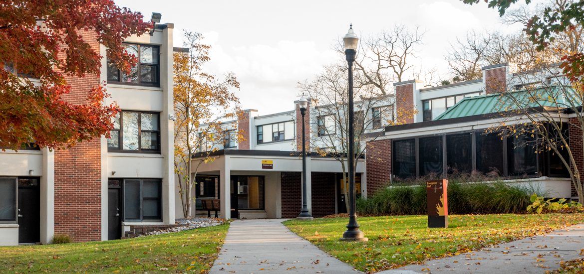 View of front door of Evergreen Hall, a one-story brick dorm.