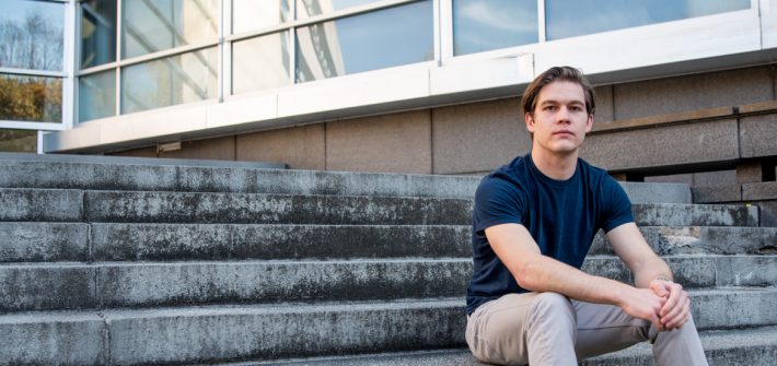 Liam sitting outside on the Engineering steps.