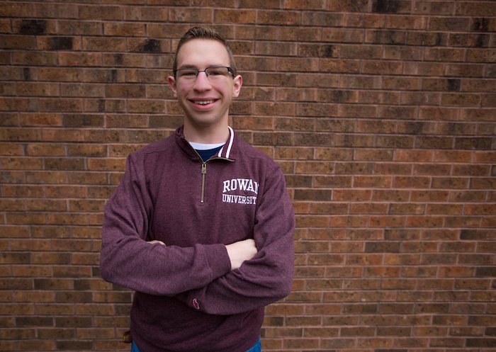 Kevin posing for a picture while wearing a Rowan Hoodie.