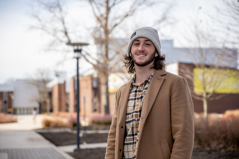 James smiling for a portrait picture taken outside Wilson Hall.