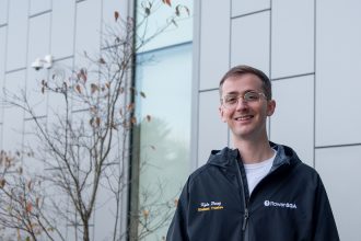 Kyle standing at Business building.