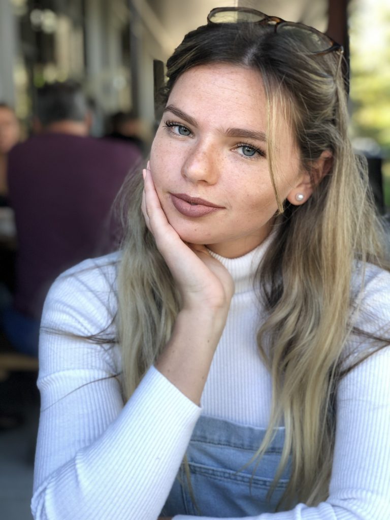 Caitlyn poses at a restaurant.