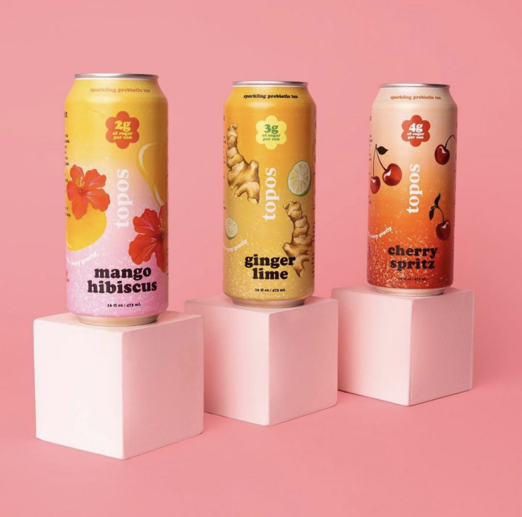 Three cans of Topos Teas.