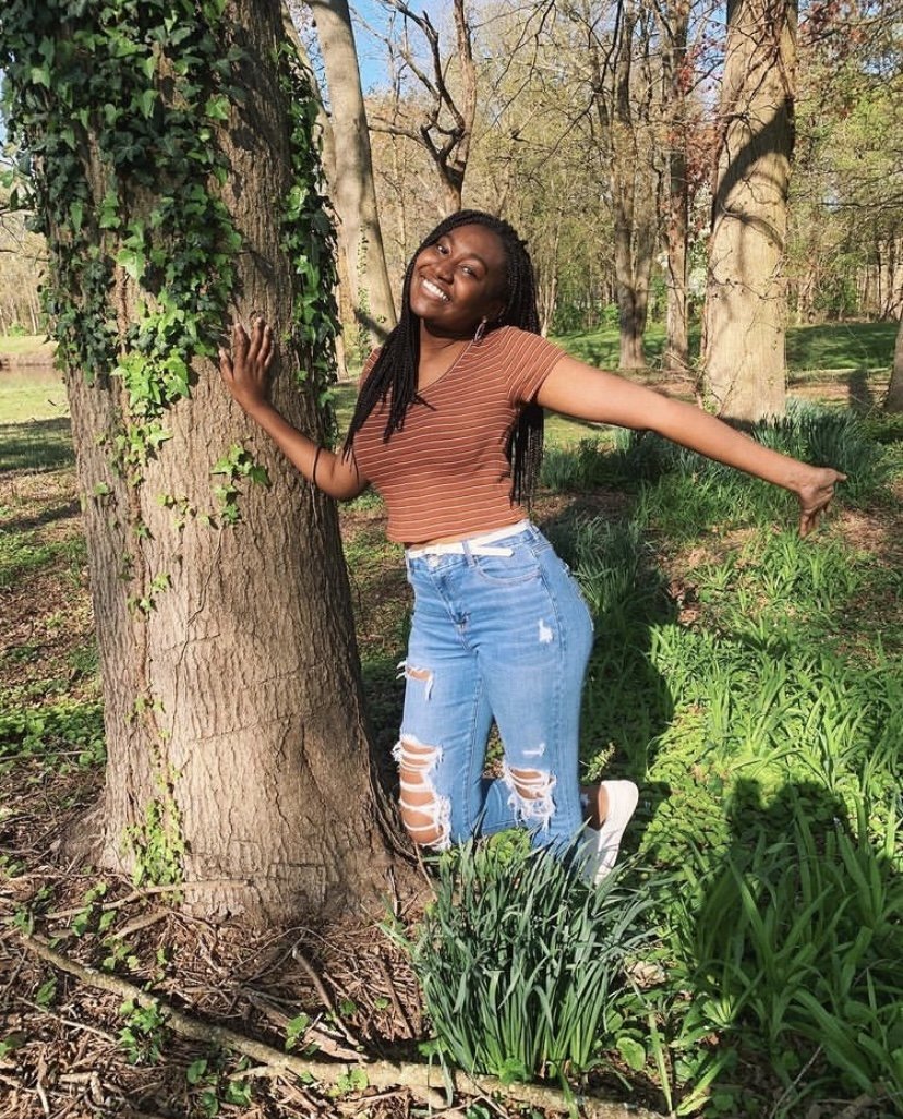 Carolyn posing against a tree.