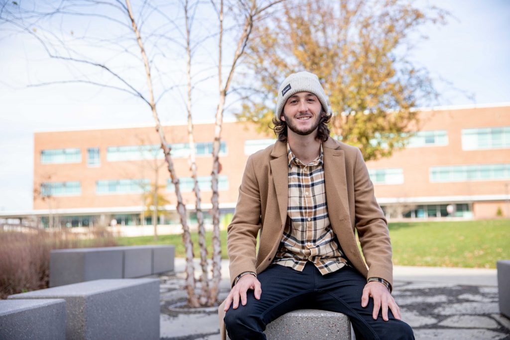 James sitting on a stone.