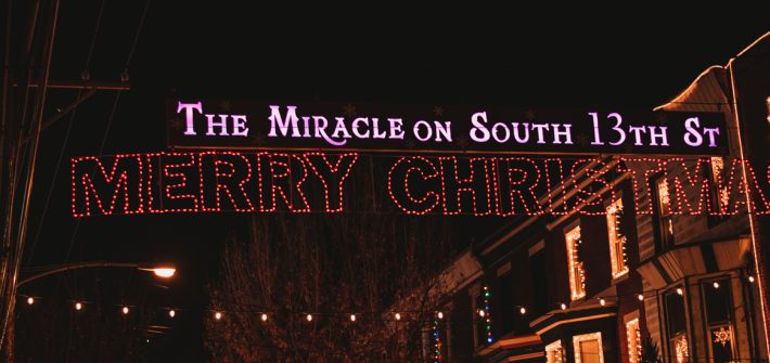 A lit up sign at night.