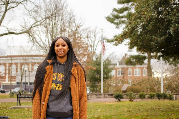 Jabreeah smiling and wearing a grey Rowan sweatshirt with a burnt orange jacket.