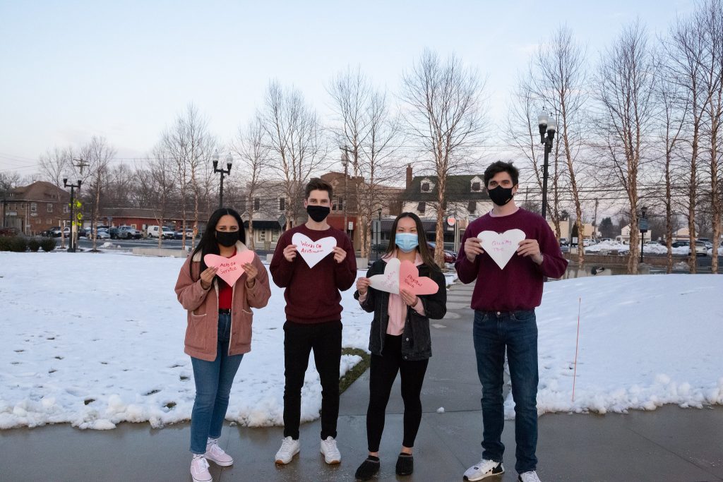 Rowan students holding love language hearts.