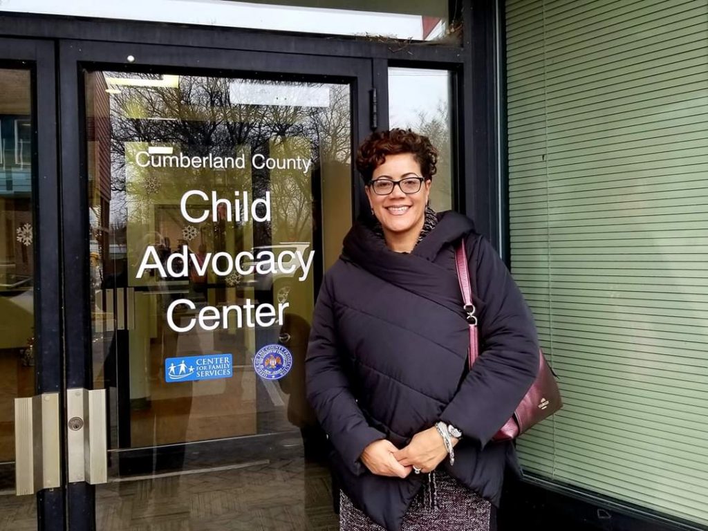 Jennifer in front of child advocacy office.
