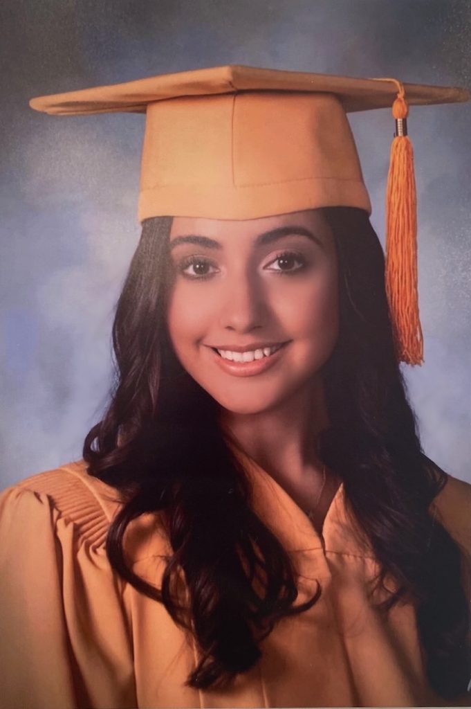 A portrait photo of Bailey in her high school graduation cap and gown.
