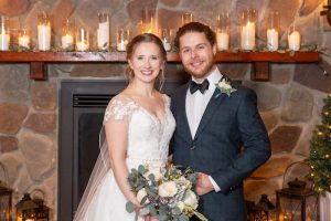 Jacob posing with his wife for a wedding photo.