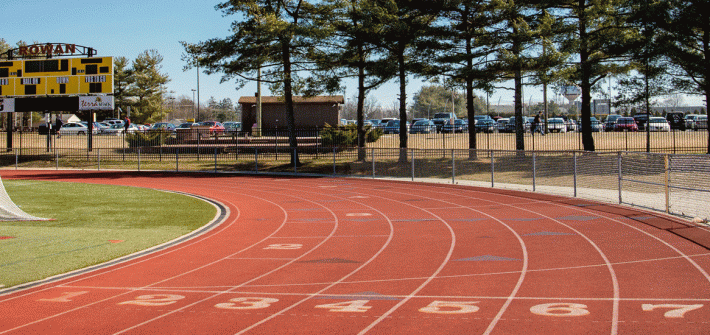 Outdoor photo of track at football field.