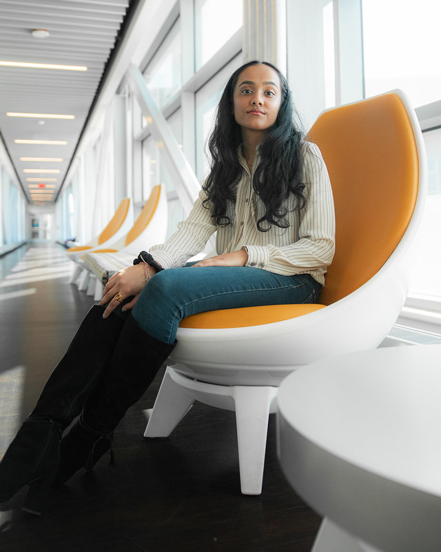 Shivani sits on a chair in the Engineering bridge.
