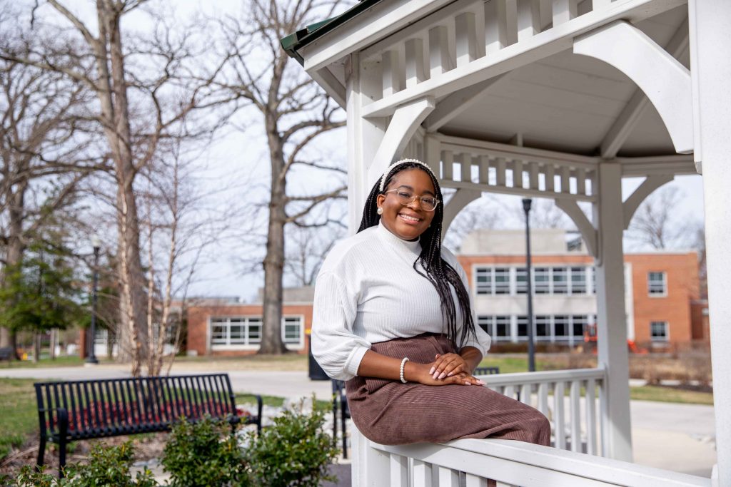 Arielle sits on a gazebo.