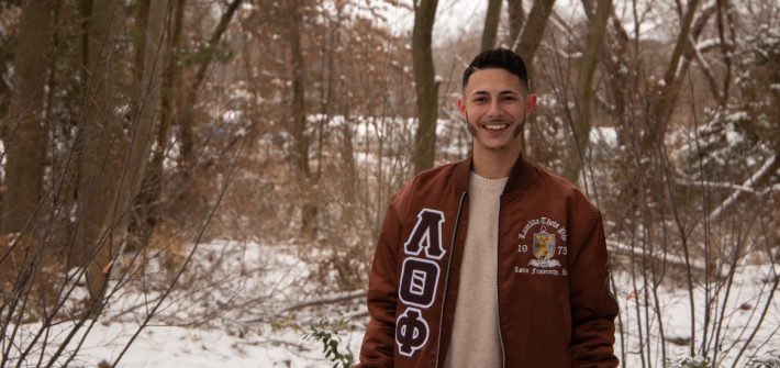 Chris Acevedo poses in a wooded, snowy area.