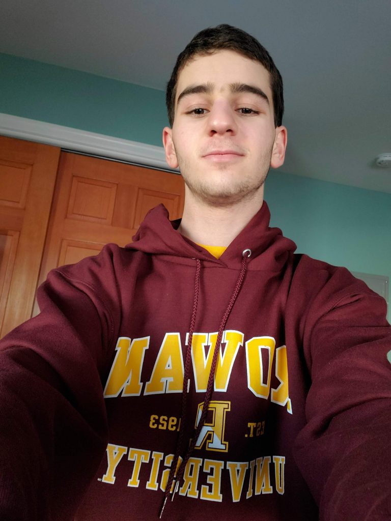 Ethan taking a selfie with a Rowan sweatshirt.