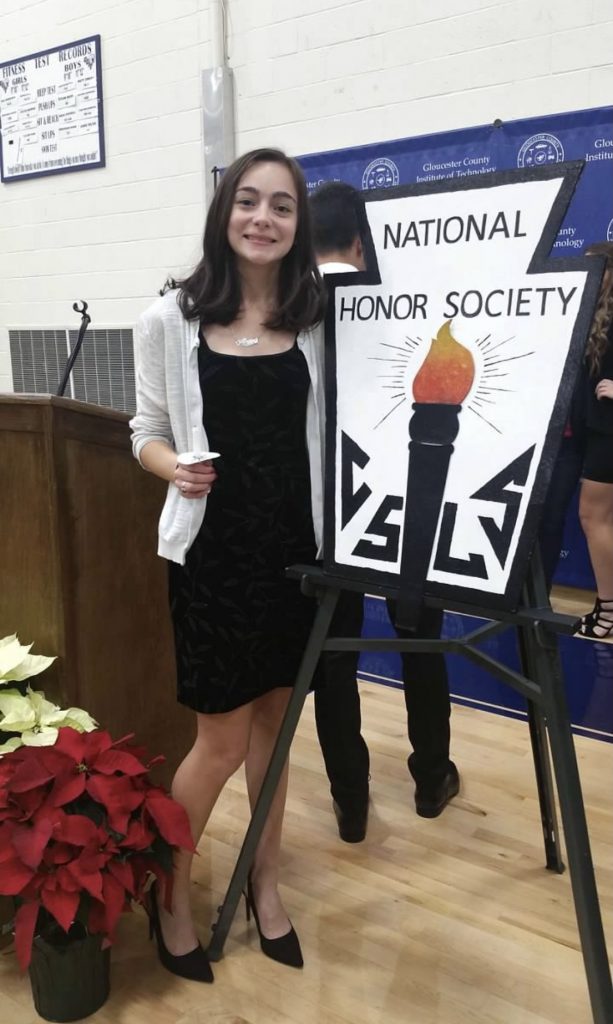 Alyssa standing next to a National Honors Society sign.
