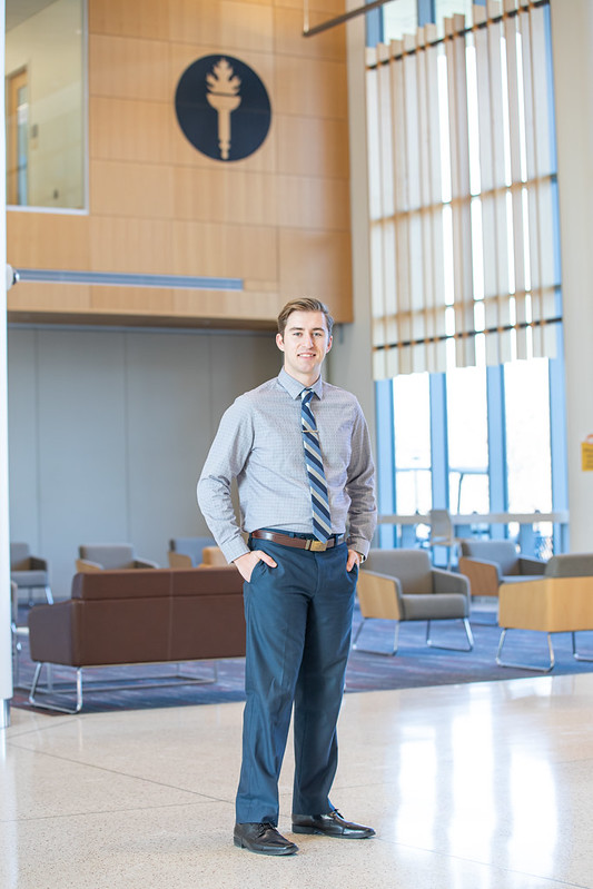 Brandon stands inside Business Hall.