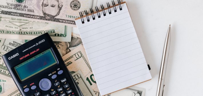 Stock image of a notepad and calculator.