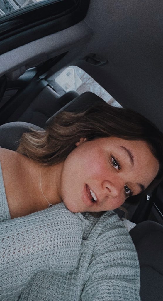 Selfie of Gianna wearing a sweater in a car.