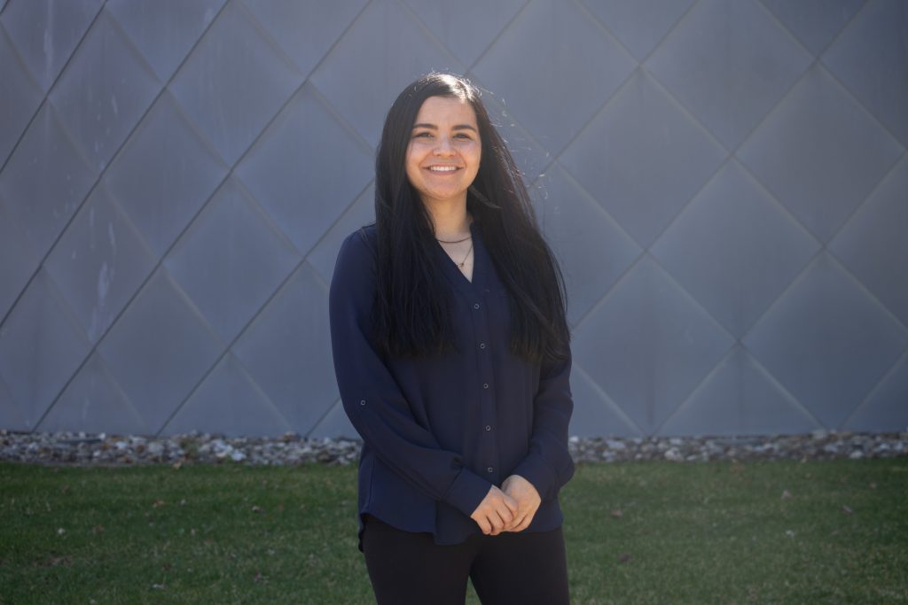 Holly poses in front of Science Hall.