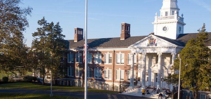 Photo taken by a drone of Bunce Hall with students sitting on the marble steps.